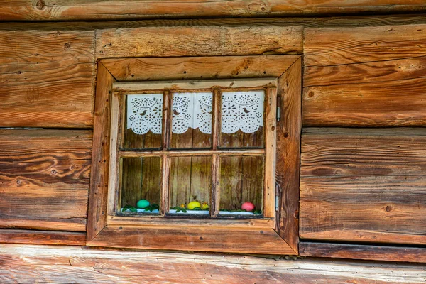 Very old grunged wooden window frame.Windows with wooden architraves .The old window of old wooden house. Background of wooden walls