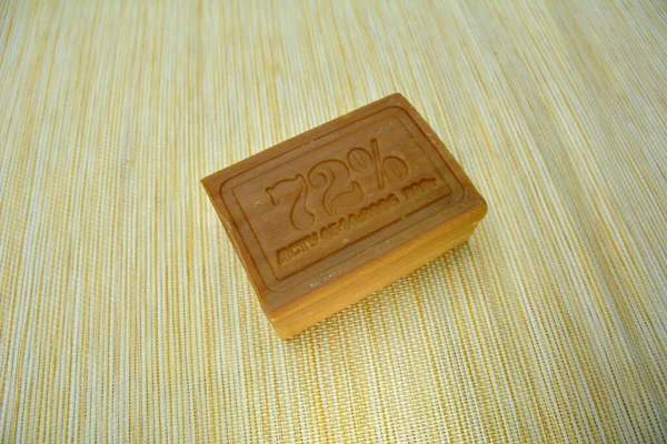 A piece of laundry soap 72 on brown paper. Single piece of eco soap close-up. Natural personal care products.