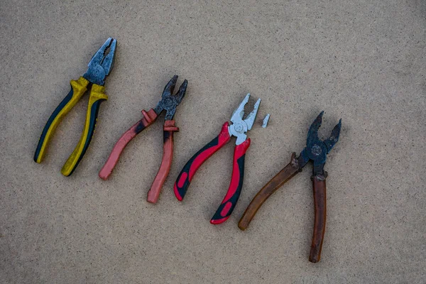 Rusted pliers. Old rusty pliers open on blurred natural background. Old working tool. Selective soft focus. Close up image.