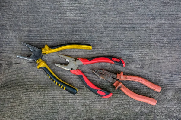 Rusted pliers. Old rusty pliers open on blurred natural background. Old working tool. Selective soft focus. Close up image.