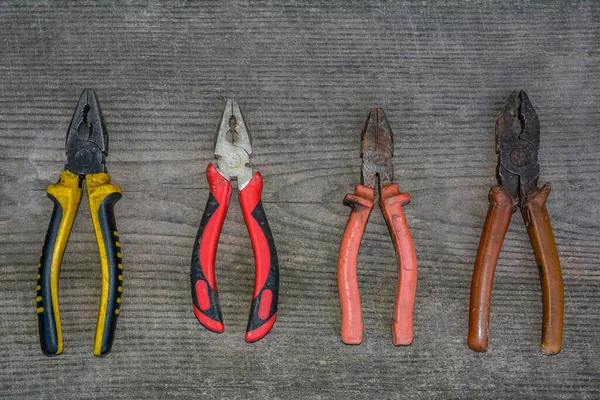 Rusted pliers. Old rusty pliers open on blurred natural background. Old working tool. Selective soft focus. Close up image.