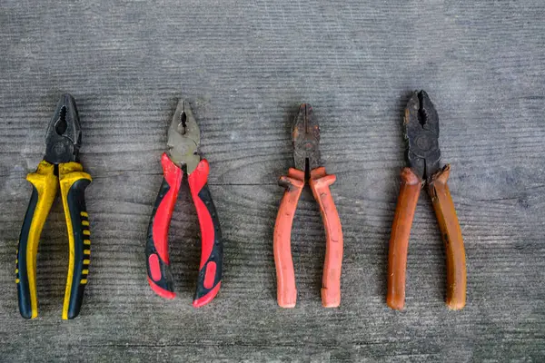 Rusted pliers. Old rusty pliers open on blurred natural background. Old working tool. Selective soft focus. Close up image.