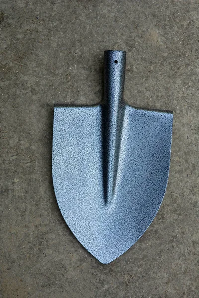 New gray metal shovel for individual use. a modern garden tool.