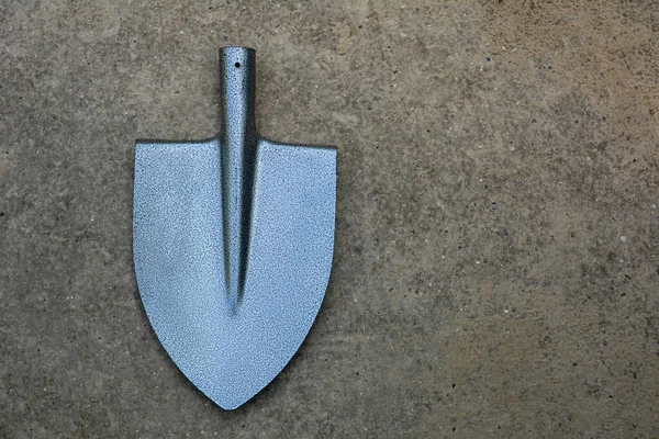 New gray metal shovel for individual use. a modern garden tool.
