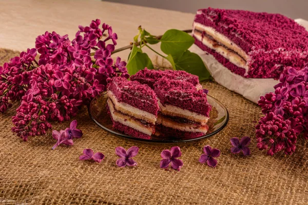 Purple cakes among spring flowers .Purple Taro Cake .