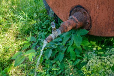 old and rusty fuel tanker trailer abandoned in a field