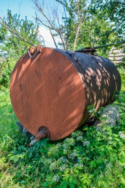 old and rusty fuel tanker trailer abandoned in a field