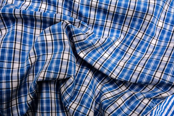 Blue white tartan texture background. shirt fabric with a checkered pattern. factory material