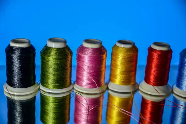 Mixture of colourful spools of thread.Yarn on a spool, cotton thread .Multi Colored threads for sewing and needlework .