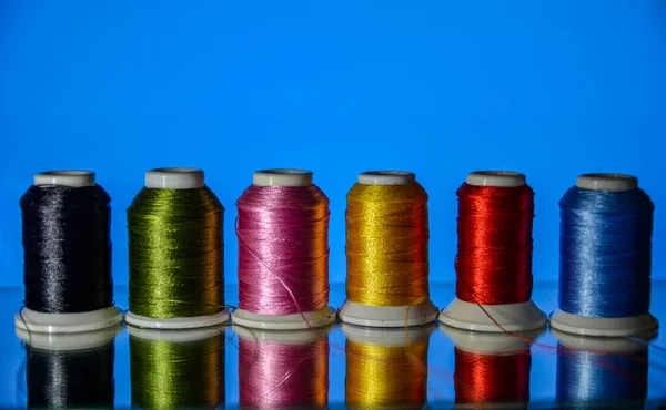 Mixture of colourful spools of thread.Yarn on a spool, cotton thread .Multi Colored threads for sewing and needlework .