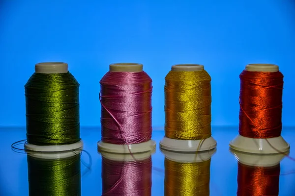 Mixture of colourful spools of thread.Yarn on a spool, cotton thread .Multi Colored threads for sewing and needlework .