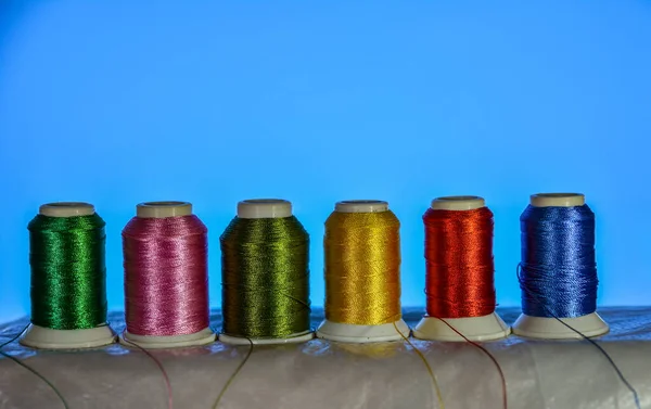 Mixture of colourful spools of thread.Yarn on a spool, cotton thread .Multi Colored threads for sewing and needlework .