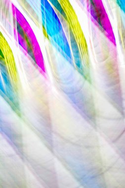 Defocused multicolored belt creating wave patterns .Multi-colored abstract blurred background of all colors of the rainbow.Striped blurred gradient.