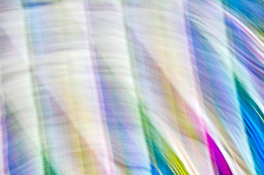 Defocused multicolored belt creating wave patterns .Multi-colored abstract blurred background of all colors of the rainbow.Striped blurred gradient.