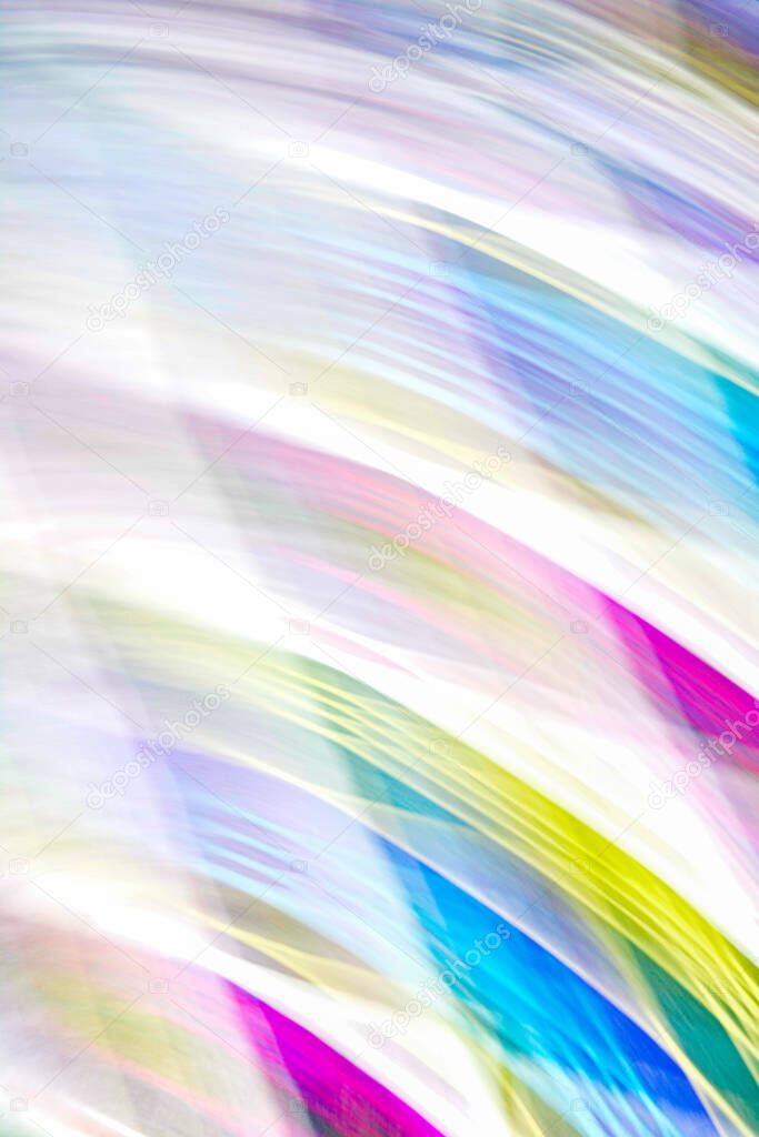 Defocused multicolored belt creating wave patterns .Multi-colored abstract blurred background of all colors of the rainbow.Striped blurred gradient.