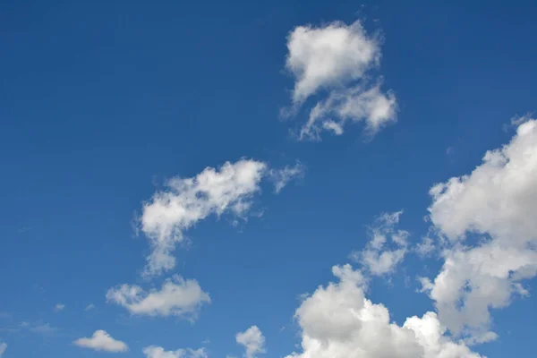 Fluffy white clouds and blue sky.Aerial view on white fluffy clouds .Background from clouds.