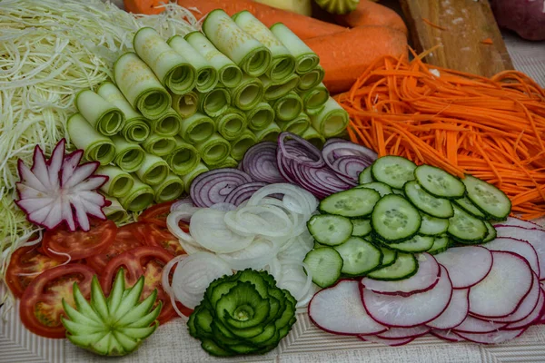 Cut vegetables ready for cooking.Cut vegetables of rainbow colors on wooden cutting board .