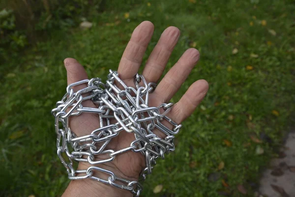 The hand is chained. The concept of the struggle for human rights. Human trafficking.