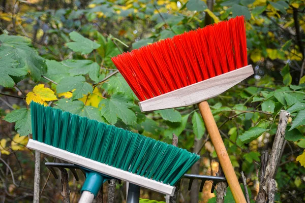 Cropped image of broom .Plastic broom .Green and red plastic broom .