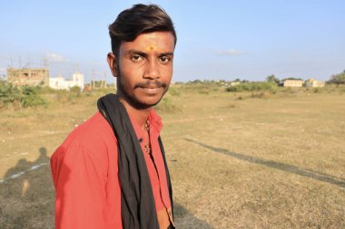Davangere, Karnataka, India - January 04, 2022: A beautiful horizontal closeup portrait of a hindu priest in pure hindu attire(Kerala Shabarimale Swamy Ayyappa attire).