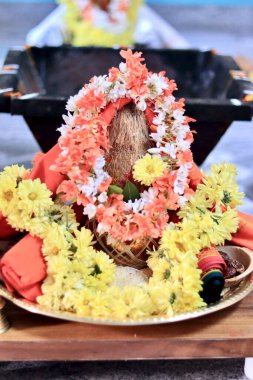 Flower and coconut offerings for Hindu religious ceremony or holy festival. A coconut treated as god.
