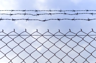 Barb wire fence and blue sky clipart