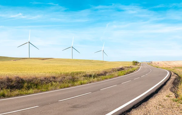 Wind turbines on summer field, green energy. — Stock Photo, Image