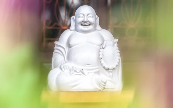 White statue of sitting and laughing fat monk. — Stock Photo, Image