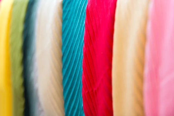 Row of new multicolored scarves at shop. — Stock Photo, Image