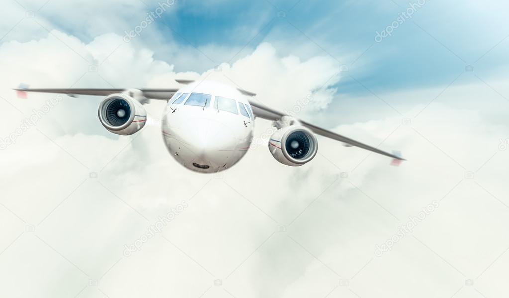 Passenger plane flying in blue cloudy sky.