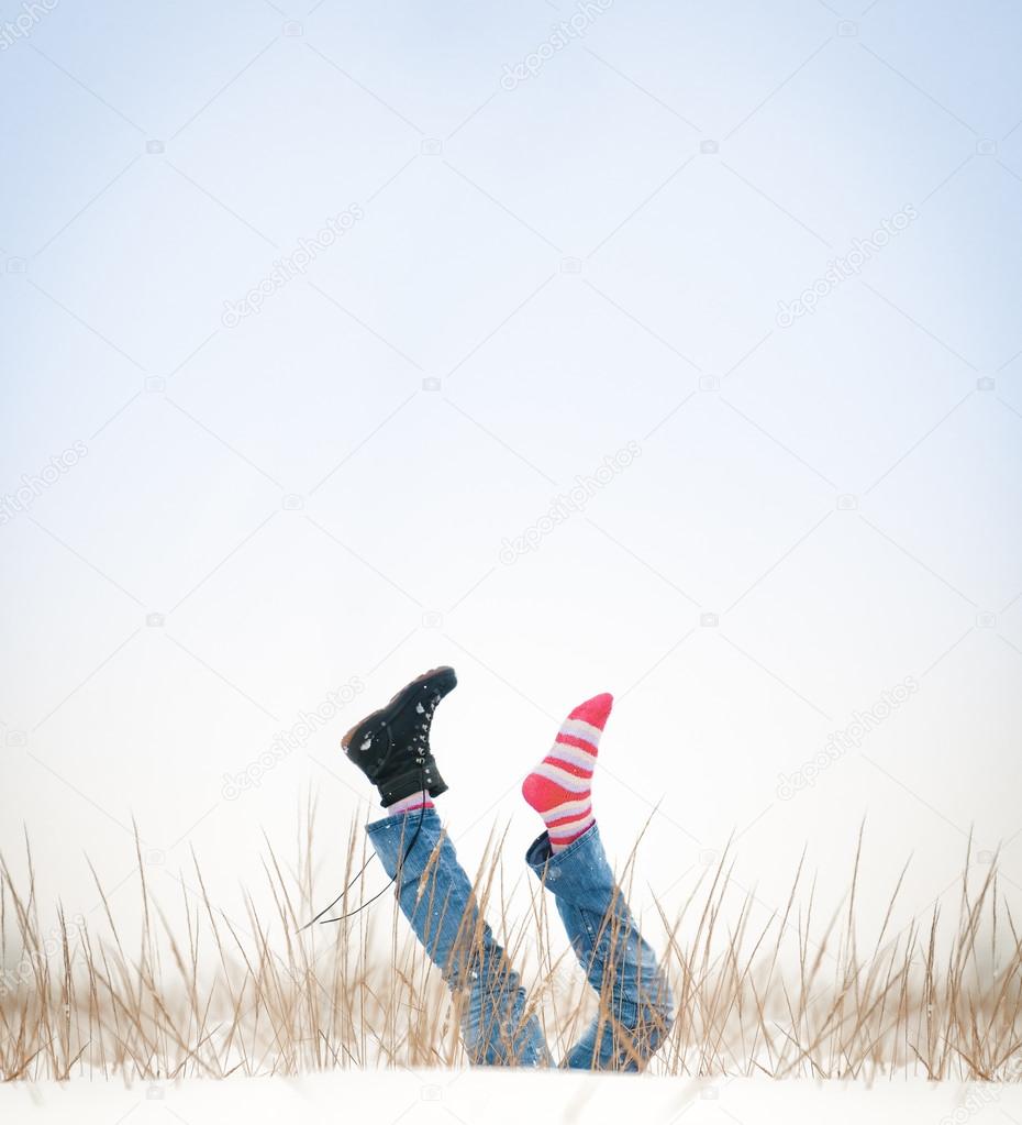 Legs with missing boot in air in winter day.
