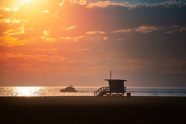 Lifeguard crew watching ocean at sunset in Santa Monica, California, United States of America