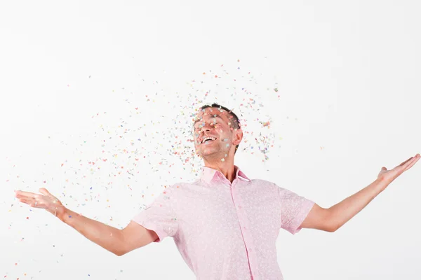 Happy man with flying confetti celebration decoration — Stock Photo, Image