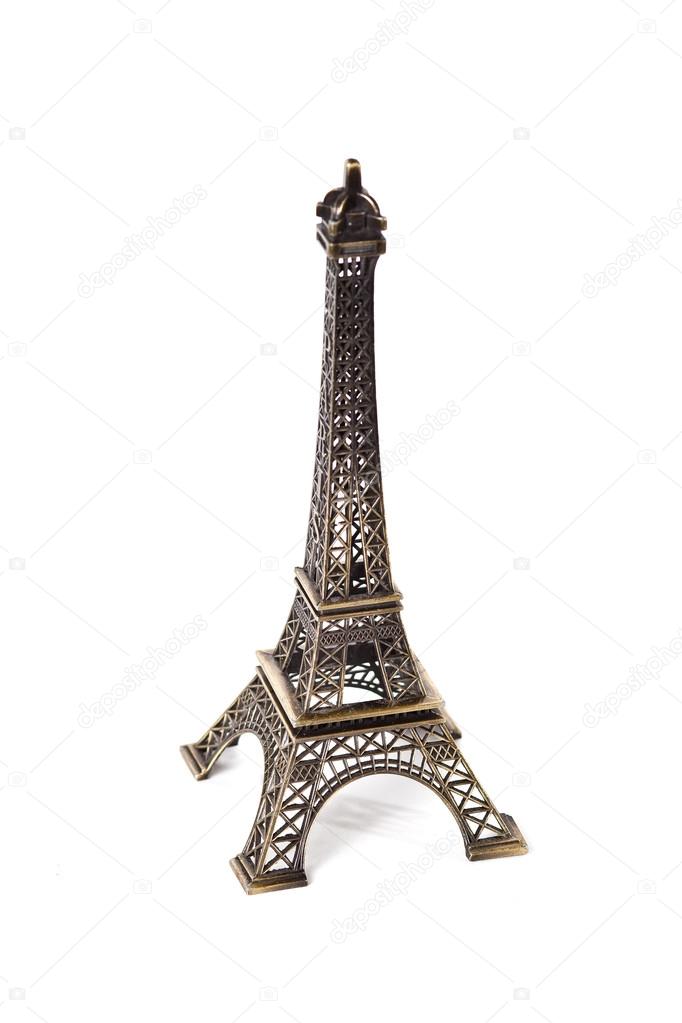 Small bronze copy of Eiffel tower figurine isolated on white background