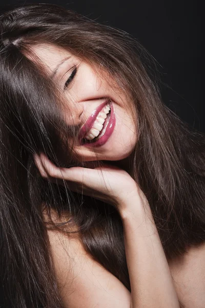 Close-up portrait of a beautiful laughing brunette model — Stock Photo, Image