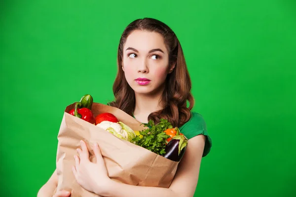 Woman with a paper bag of vegetables — Stock Photo, Image