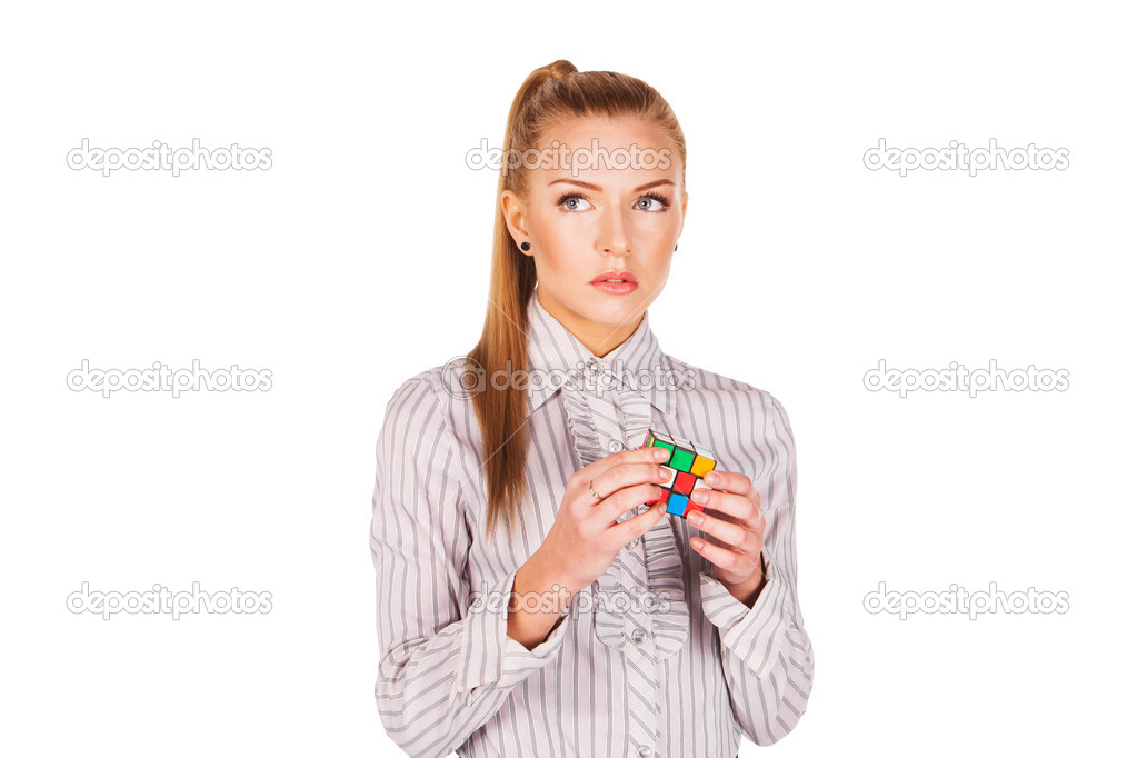 Young woman concentrated solving the Rubik's Cube