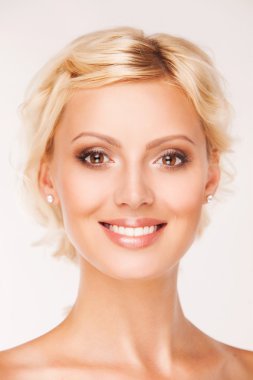 Portrait of beautiful smiling woman with healthy teeth on white background
