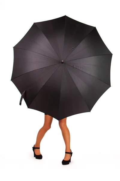 Woman standing behind an umbrella hiding her bust — Stock Photo, Image