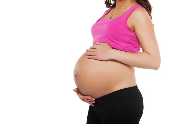 Zbliżenie kobiety w ciąży z rękami nad brzuchem — Zdjęcie stockowe