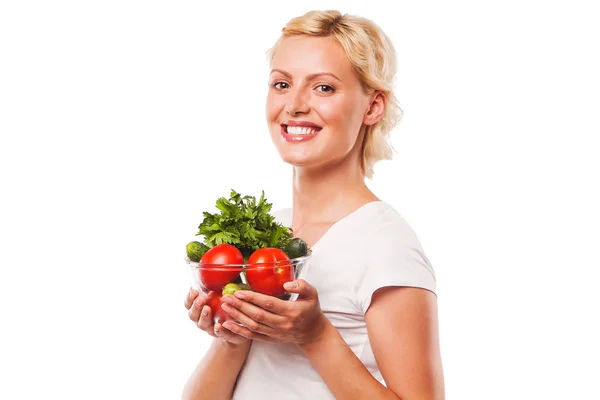 Close-up of healthy smiling woman holding fresh vegetable salad in glass bowl — Stock Photo, Image