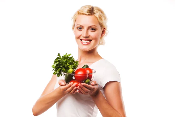 Close-up of pretty girl holding fresh vegetable salad in glass bowl . on white — Stock Photo, Image