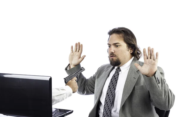 Man on computer with gun — Stock Photo, Image