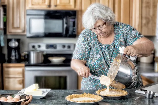 Active grandmother baking — Stock Photo, Image