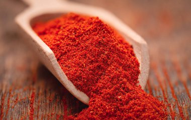 Ahşap kepçeyle kurutulmuş kırmızı biber yakın plan.