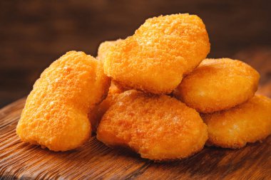 Homemade chicken nuggets on a cutting board close-up