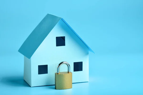 House model and padlock: protection and security concept