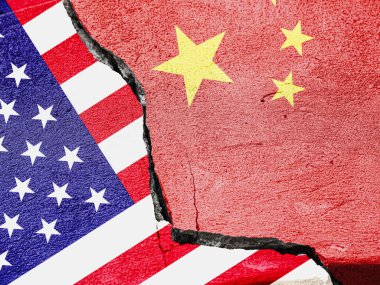 Flags of China and the United States of America on a cement plaster of a cracked wall