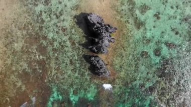 Aerial view with a drone over a transparent blue lagoon in El Nido, Philipplnes. Beautiful landscape in paradise, perfect for travel in nature under the sun 4K