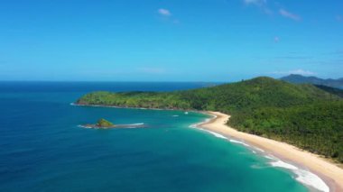 Aerial view of the white-sand beach of El Nido, Philippines. We can see mountains and palm trees forest in the background, perfect for summer travel in nature 4K